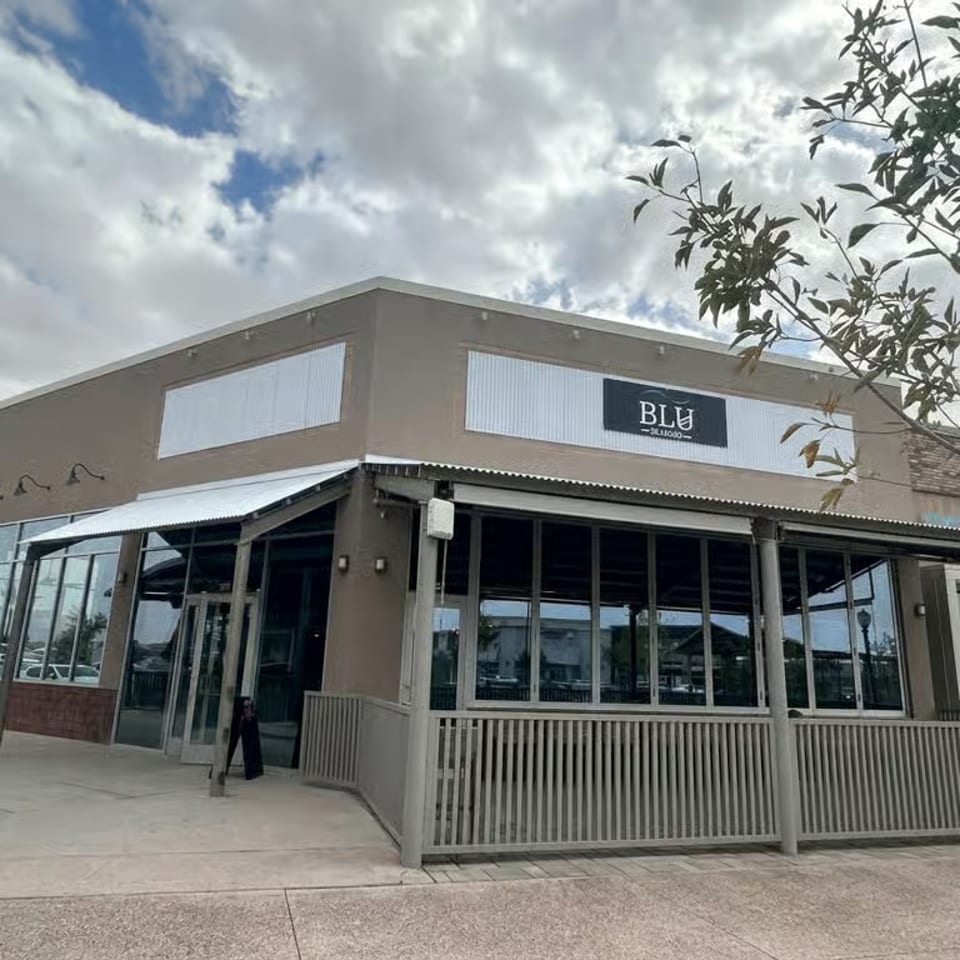 Exterior of Blu Seafood restaurant with a patio, large windows, and a prominent sign.