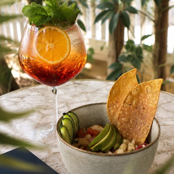A Blu restaurant menu, a cocktail with orange and mint, and a ceviche bowl with chips.